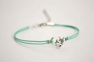 Turquoise cord bracelet with a silver Om charm, yoga jewelry