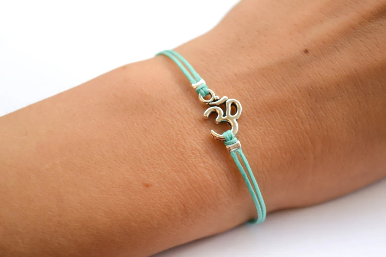 Turquoise cord bracelet with a silver Om charm, yoga jewelry